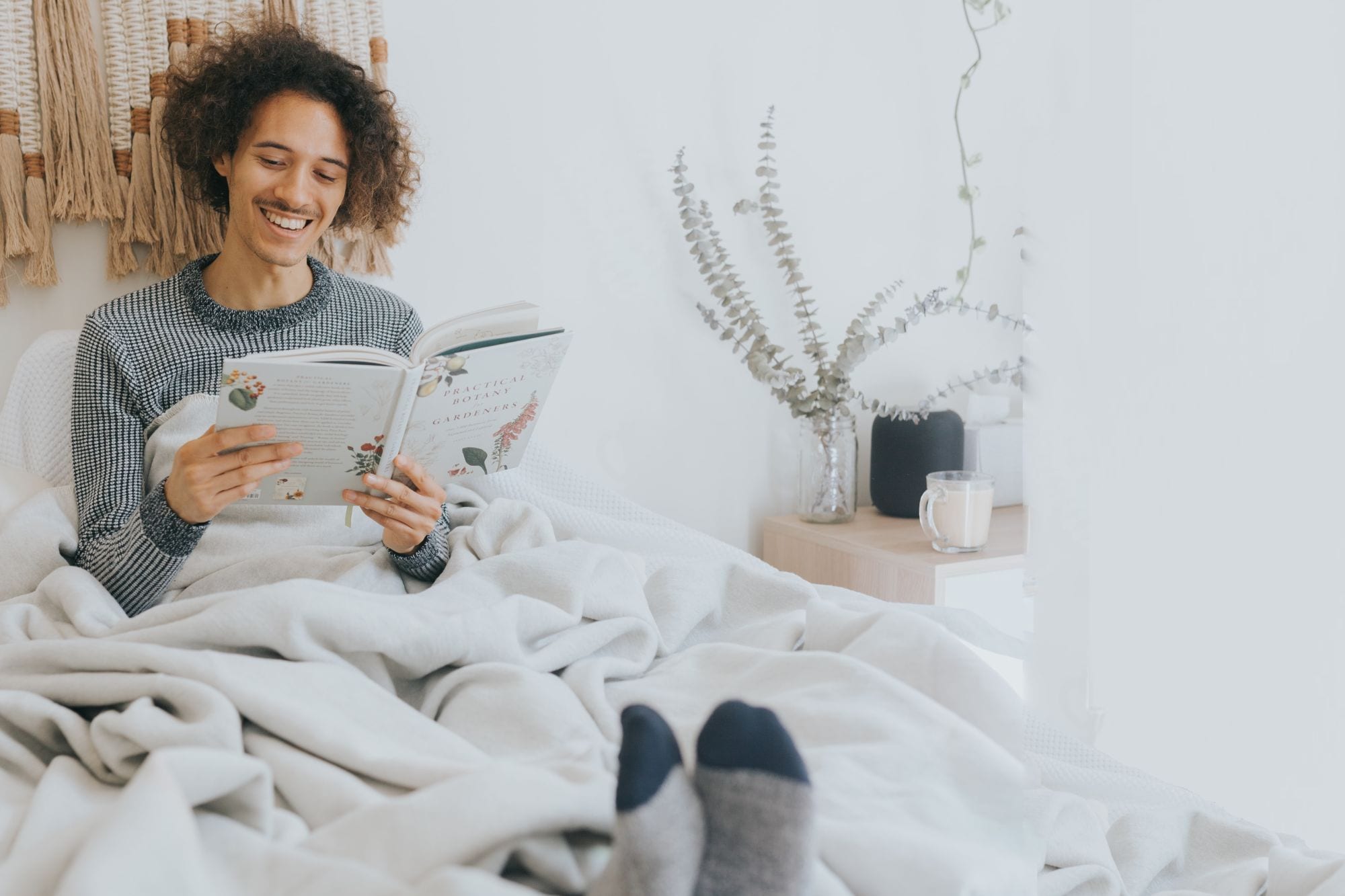 Man in bed reading; bamboo socks