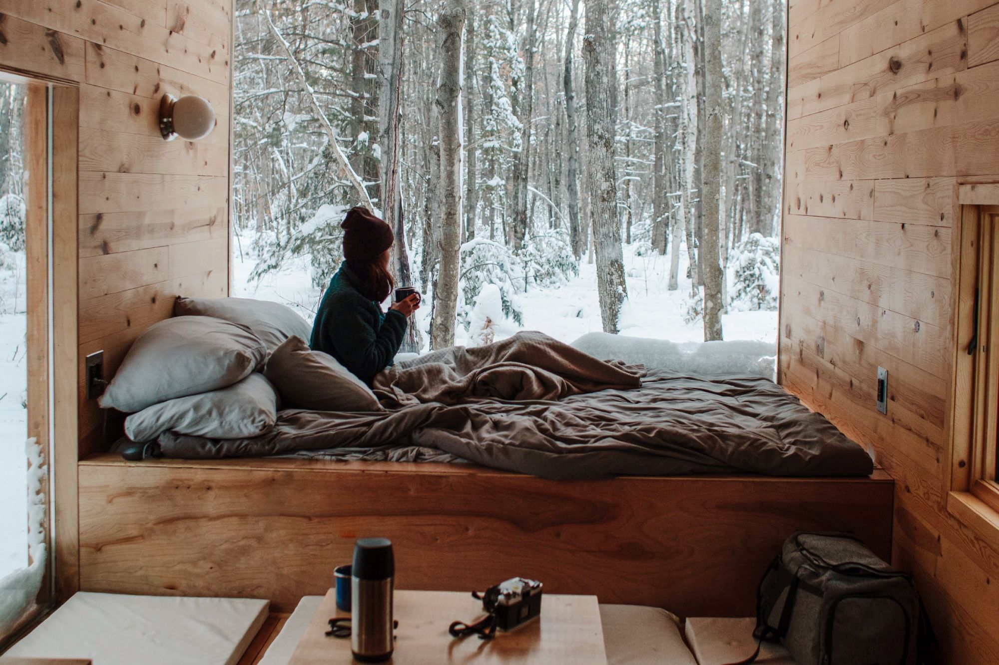 Person in bed looking outside at snow; bamboo blankets