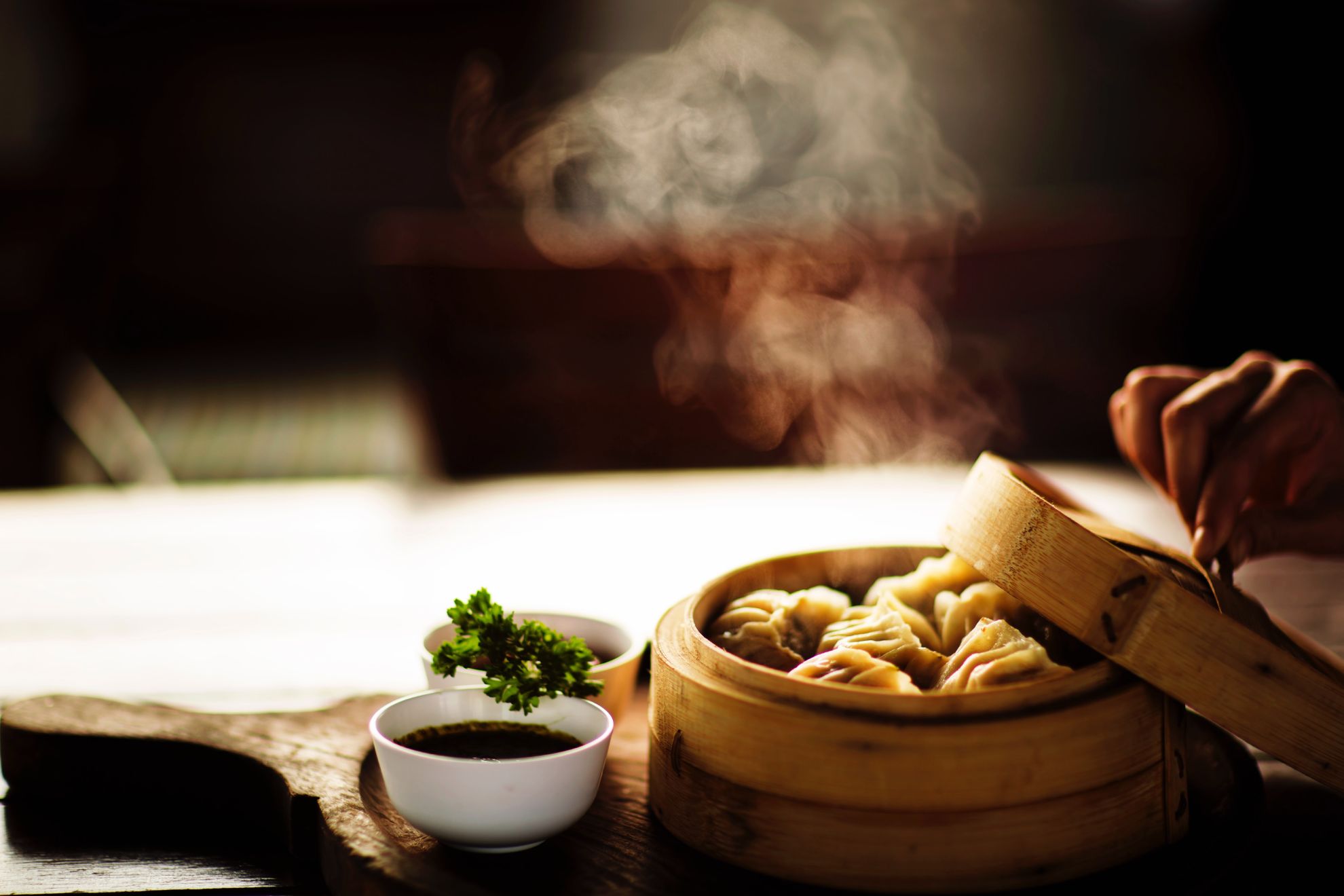 Freshly cooked dumplings in a bamboo steamer