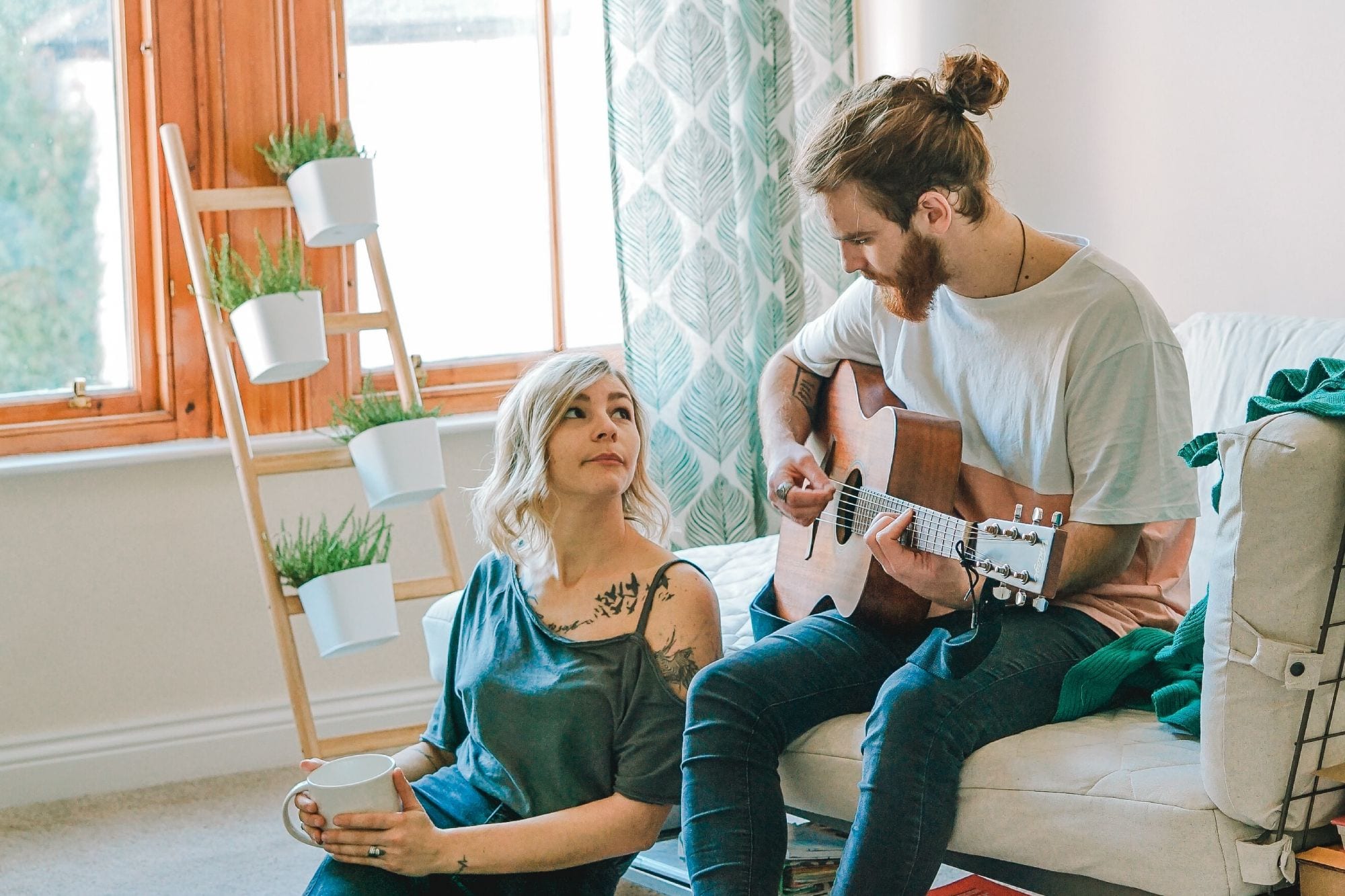 Couple playing guitar; bamboo plant stand